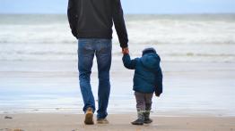 Father and son walking on beach